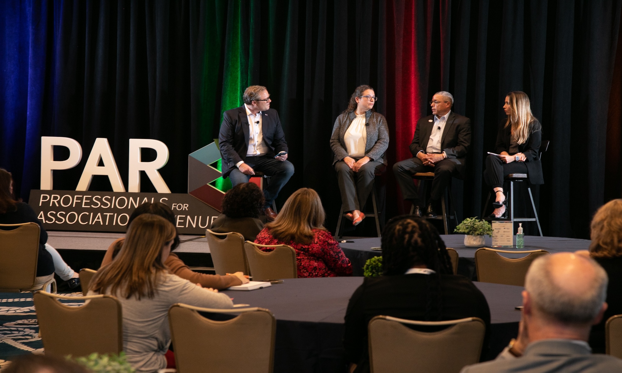 3 Pierre Award finalists on stage with PAR Chair Sean Soth during the 2023 RevUP Summit, discussing how non-dues revenue plays a critical role in maintaining their financial health.